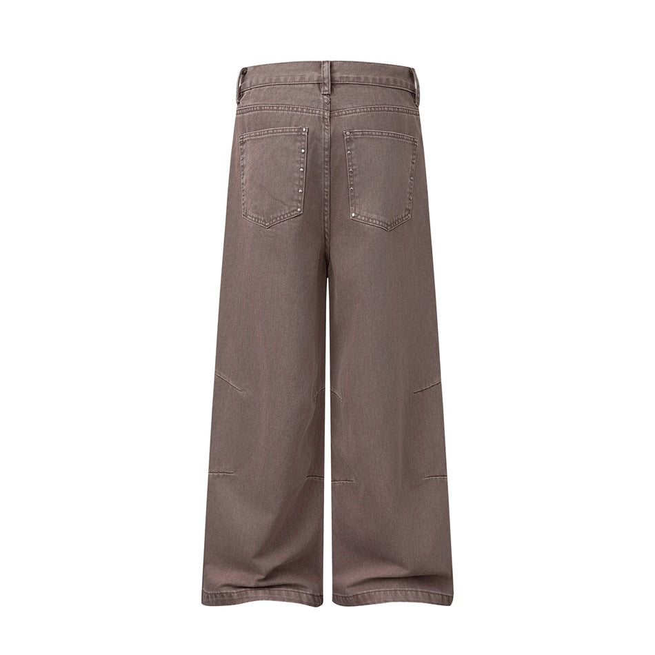 Full-length rear view of taupe wide-leg jeans with two studded back pockets and a clean white background.