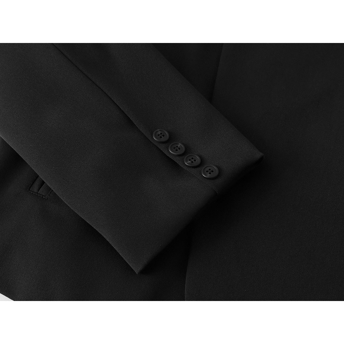 Close-up of a black jacket sleeve cuff with four buttons and a glimpse of a pocket.