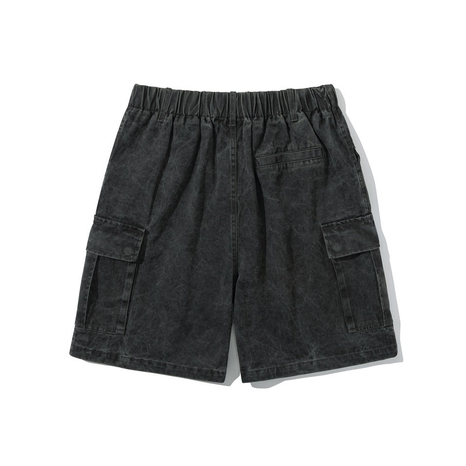 Back view of black washed cargo shorts with an elastic waistband, rear pocket, and side cargo pockets.