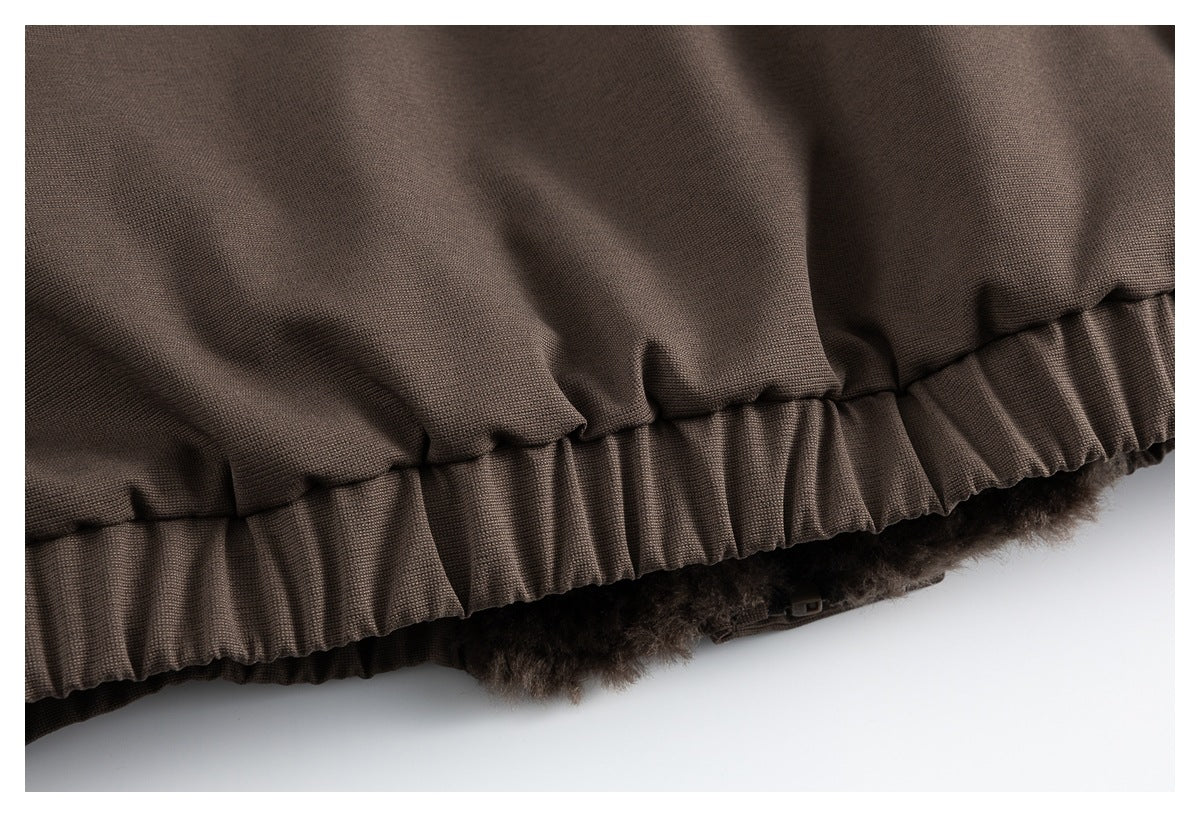 Close-up of a brown garment hem with a gathered edge and plush lining visible beneath.