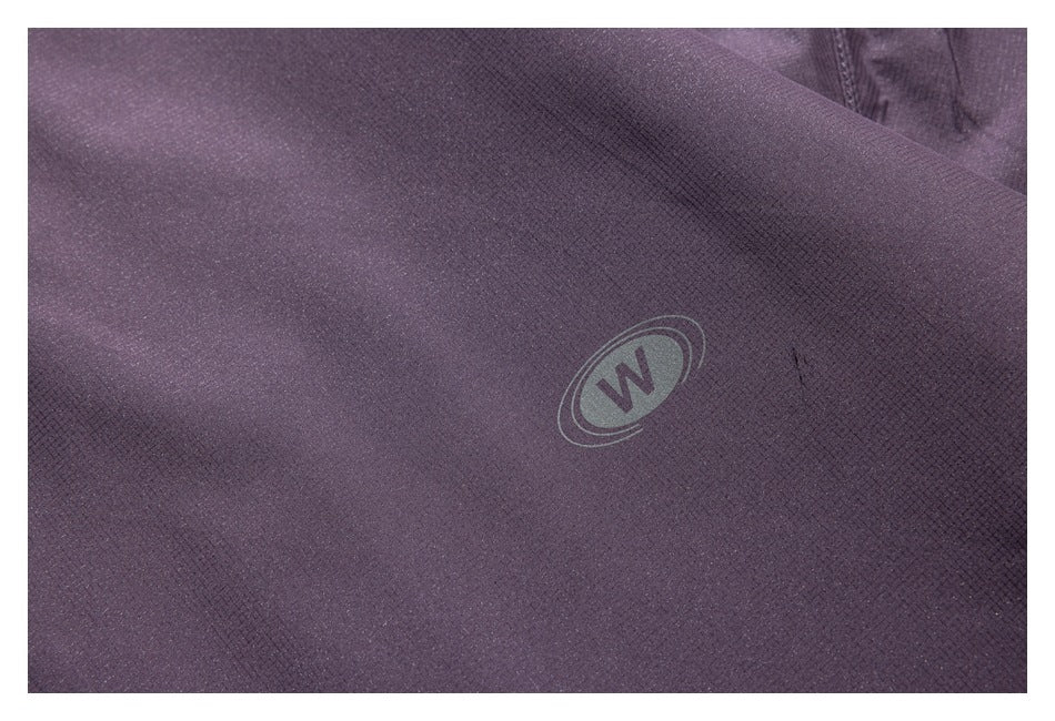 Close-up of a small circular W emblem on purple jacket fabric.