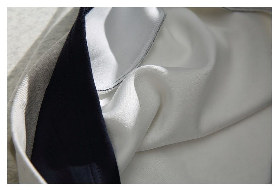 Close-up of the sweatshirt's white inner panel, stitching, and dark navy neckline trim.