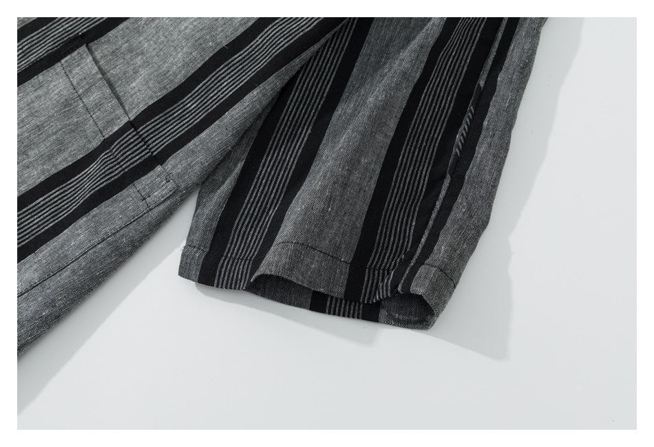 Close-up of a sleeve and cuff on the black and gray striped shirt.