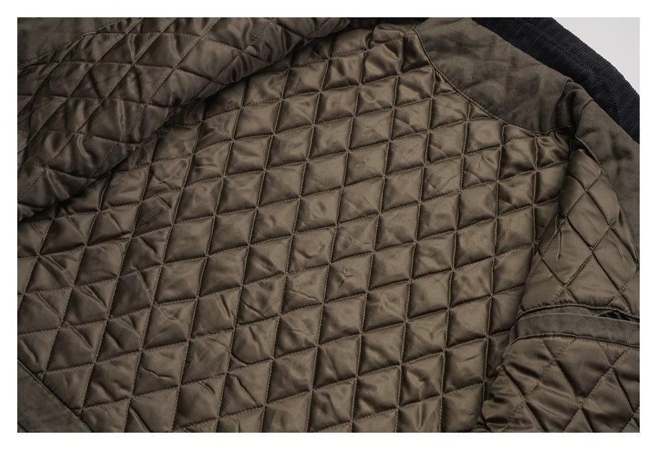 Close-up of a brown quilted jacket interior with geometric stitched panels and black ribbed trim.