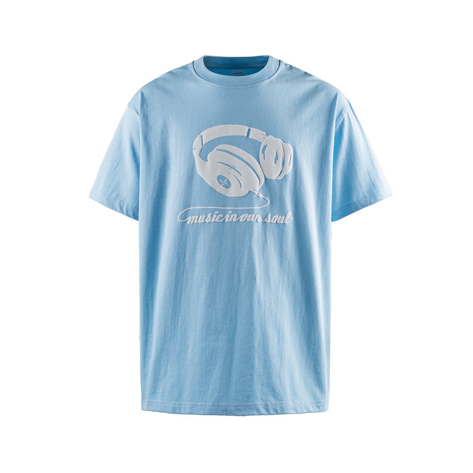 Light blue short-sleeve T-shirt with white raised headphone graphic and 'music in our soul' script, front view