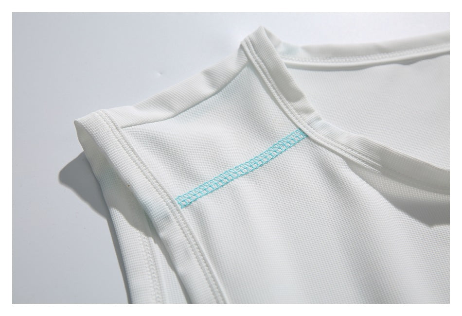 Close-up of a white garment's shoulder and armhole, with a turquoise stitched seam.