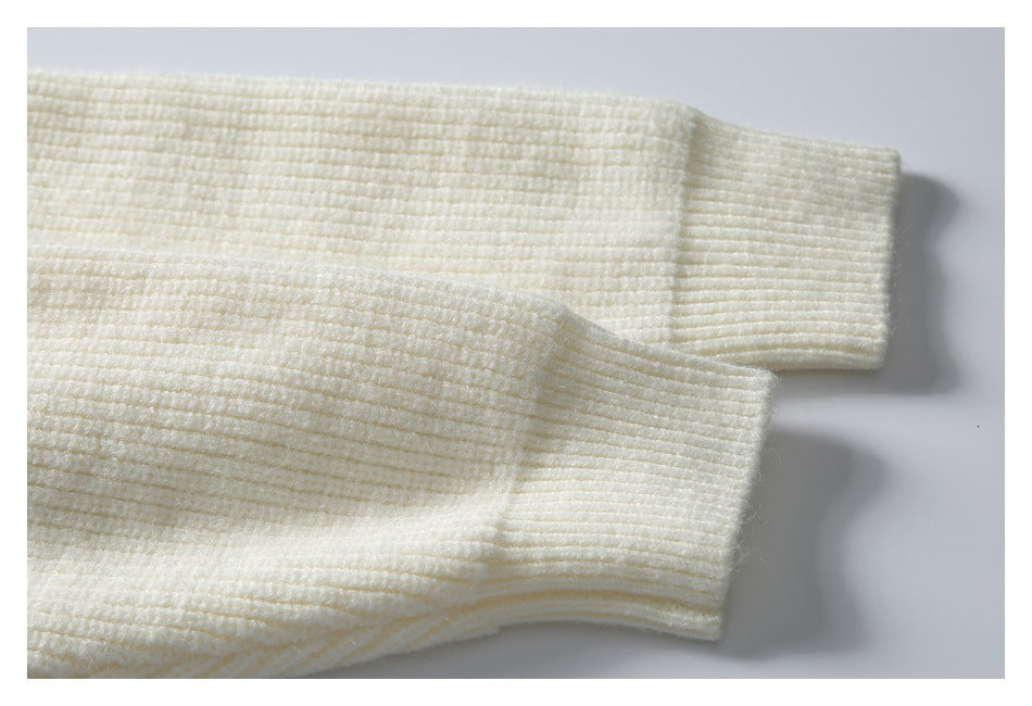 Close-up of the ivory cardigan's ribbed knit sleeve and cuff.