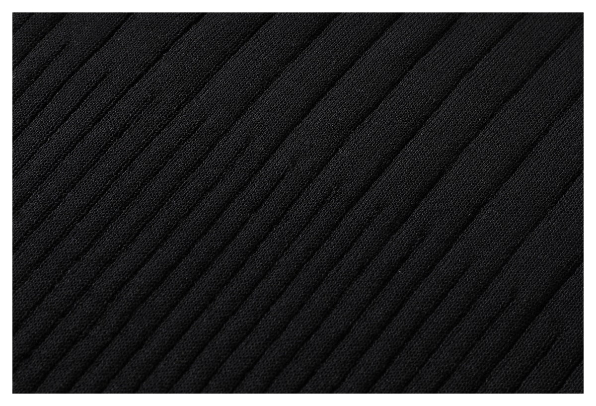 Extreme close-up of black fabric with evenly spaced diagonal ribbed lines.