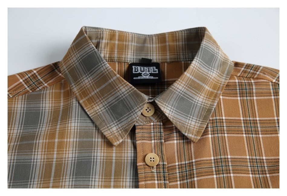 Close-up of the shirt's pointed collar and upper button placket in contrasting brown, gray and cream plaid.