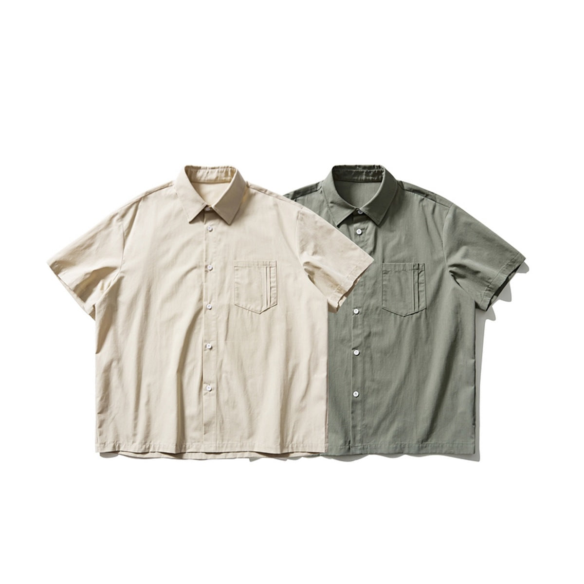 Front view of two short-sleeve button-up shirts, one beige and one muted gray-green, each with a chest pocket.