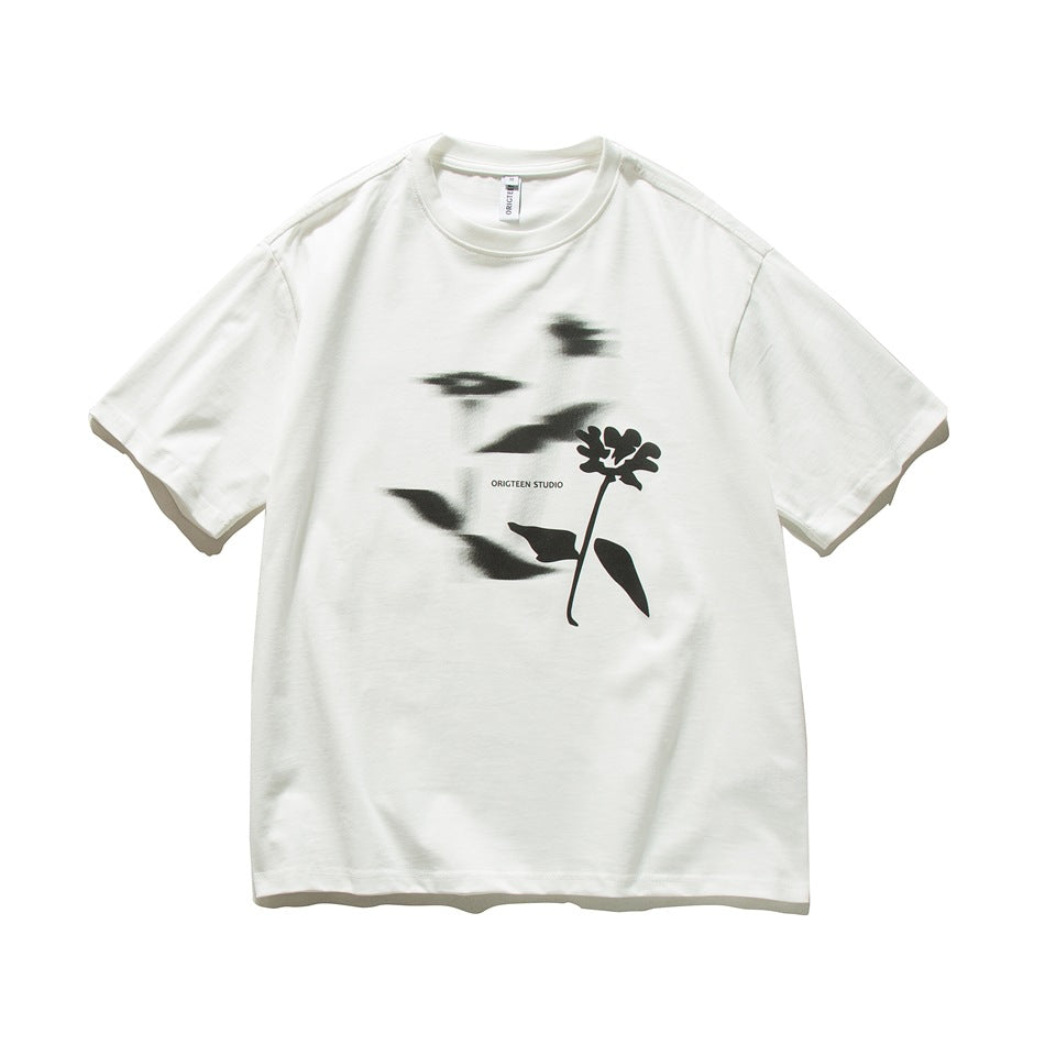 White short-sleeve crew-neck T-shirt with blurred black flower silhouette graphic on the front, flat lay