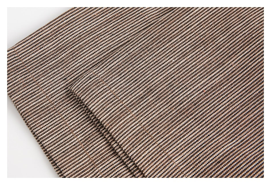 Close-up of black-and-cream geometric patterned fabric with a curved stitched seam.