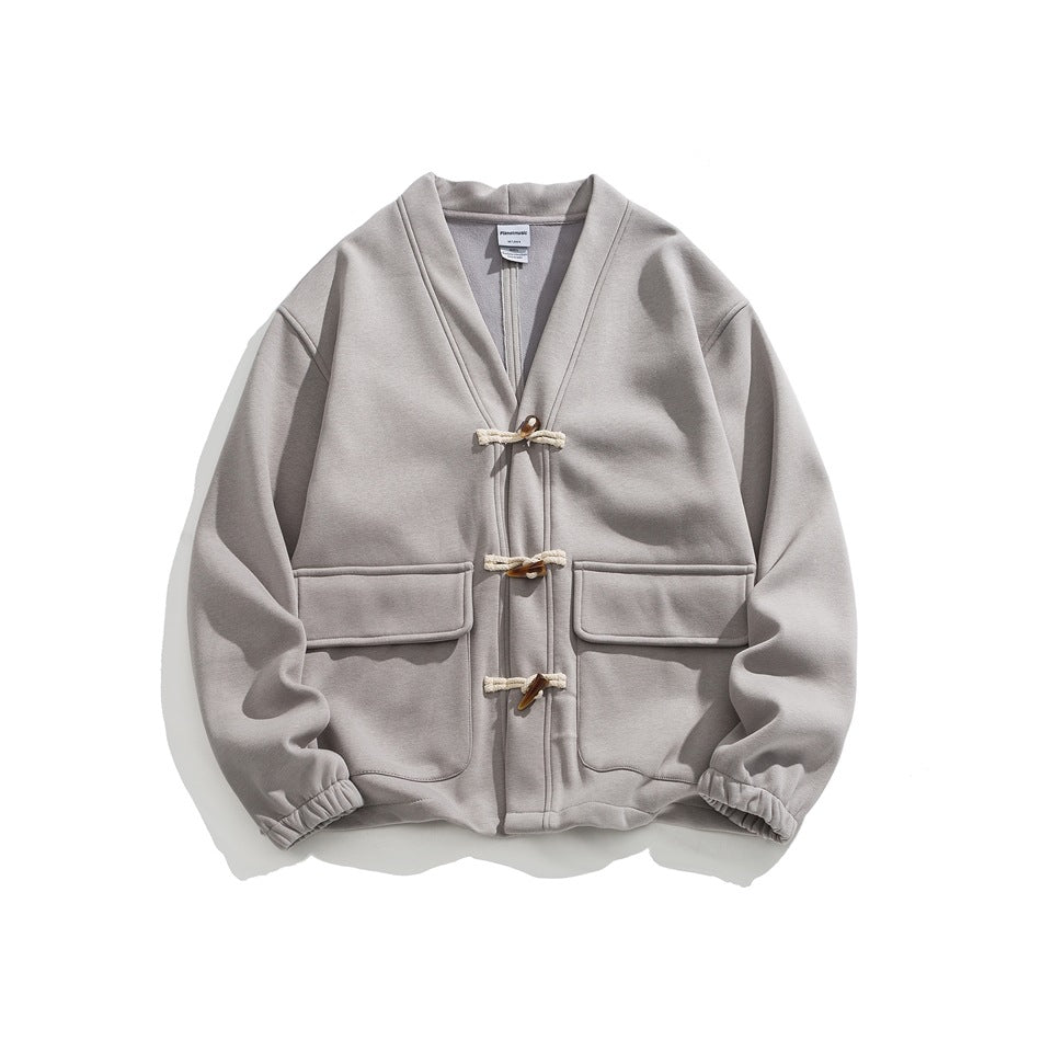 Gray V-neck jacket with three toggle closures, flap pockets and elastic cuffs, flat lay