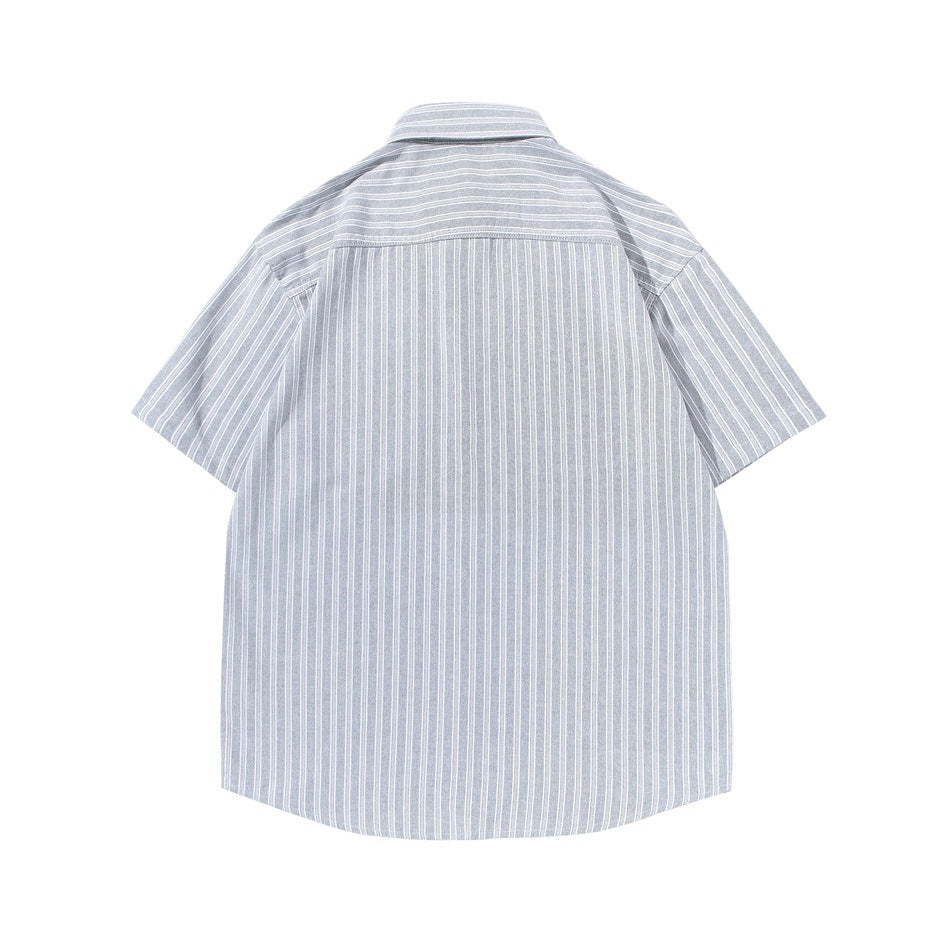 Back view of gray and white vertical-striped short-sleeve shirt with back yoke seam, laid flat
