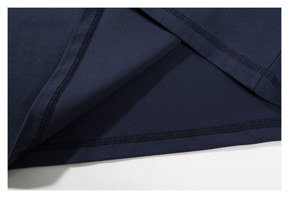 Close-up of the navy T-shirt’s interior fabric and overlocked hem seams.