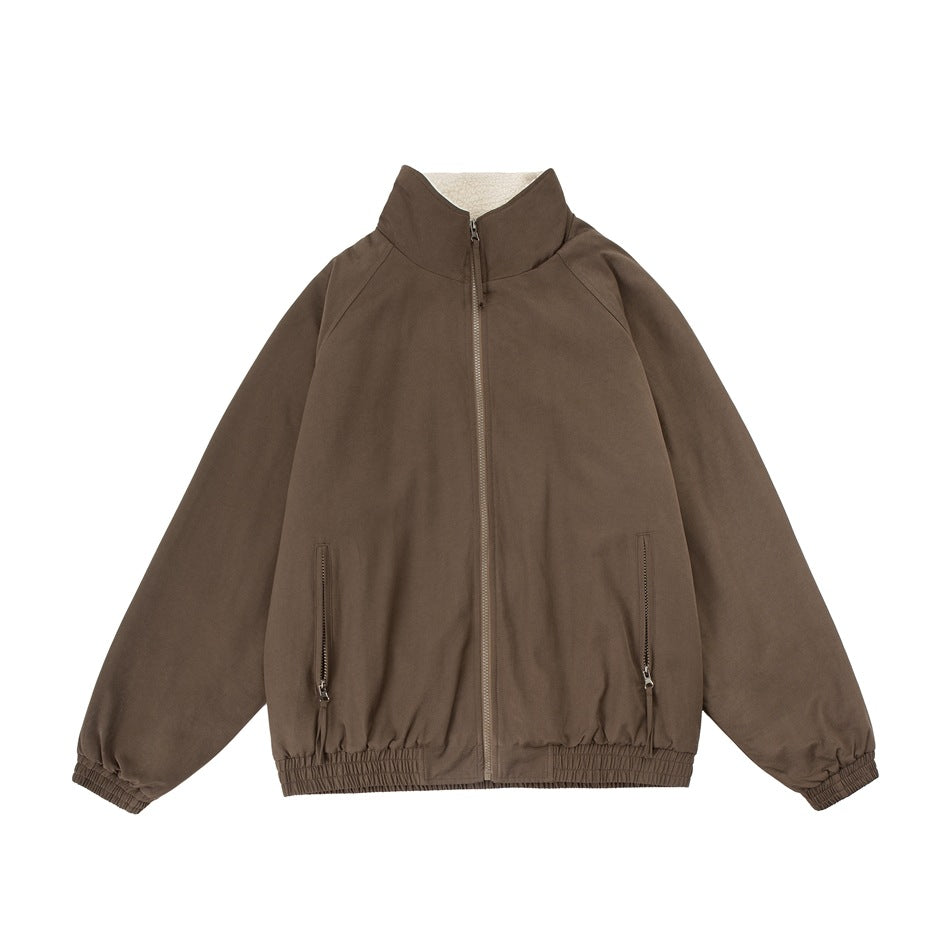 Front view of a brown zip-up jacket with a high collar, two zip pockets, and elasticated cuffs and hem.