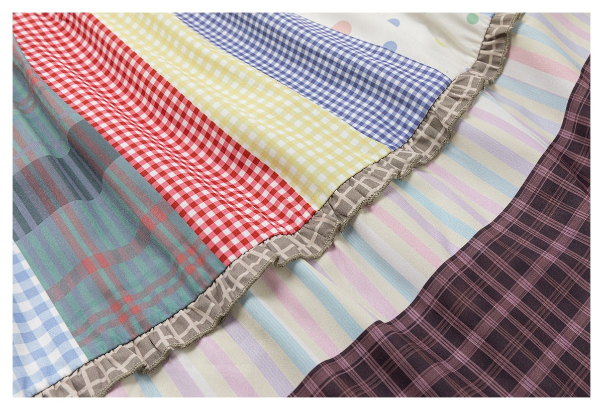 Close-up of lower skirt tiers with gingham, pastel stripes, dark plaid, and ruffled trim.