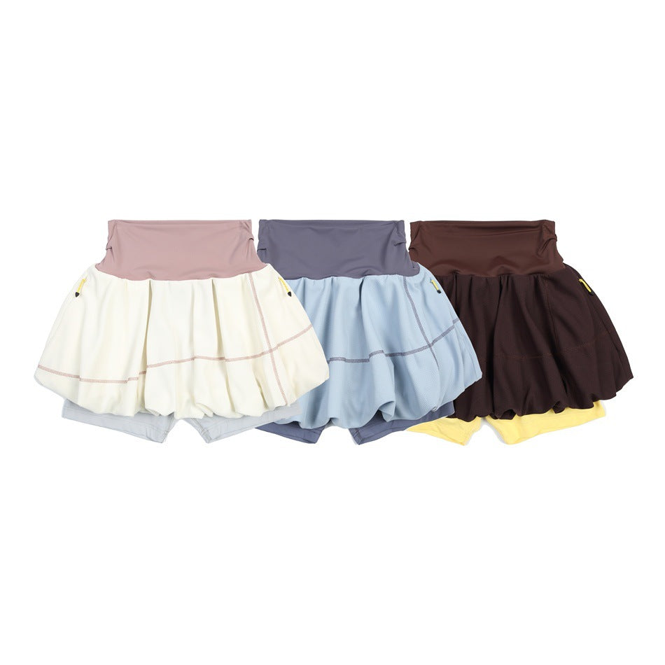 Three bubble tennis skirts displayed together in cream, light blue, and dark brown, each with contrasting built-in shorts.