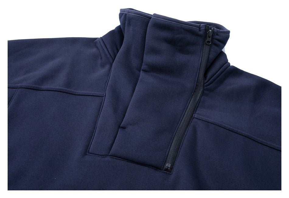 Close-up of a navy pullover's high collar and partially zipped front closure.