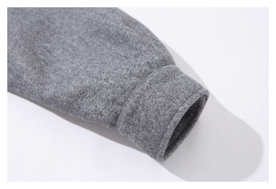 Close-up of a gray jacket sleeve ending in a wide folded cuff.