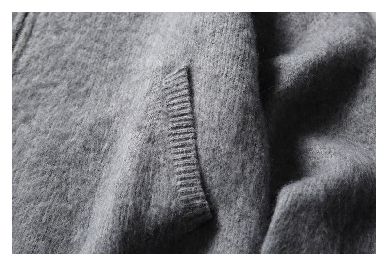 Close-up of a slanted pocket opening on a gray fuzzy cardigan.