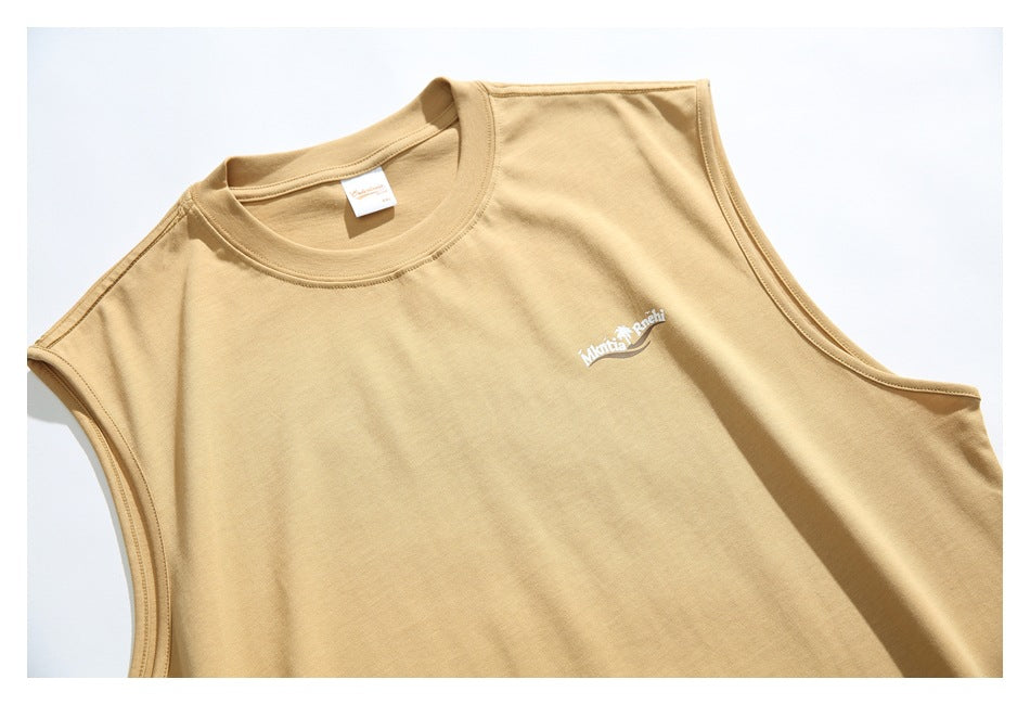 Close view of the sand-colored shirt's upper front, crew neck, armholes, and small white chest logo.