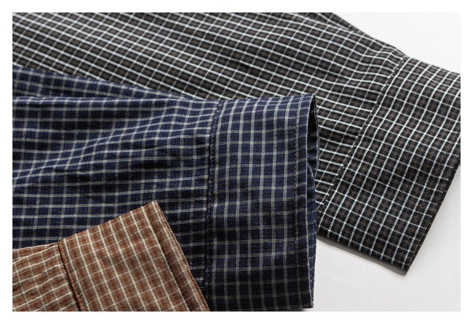 Close-up of three overlapping checked shirt sleeves in black, navy, and brown colorways.