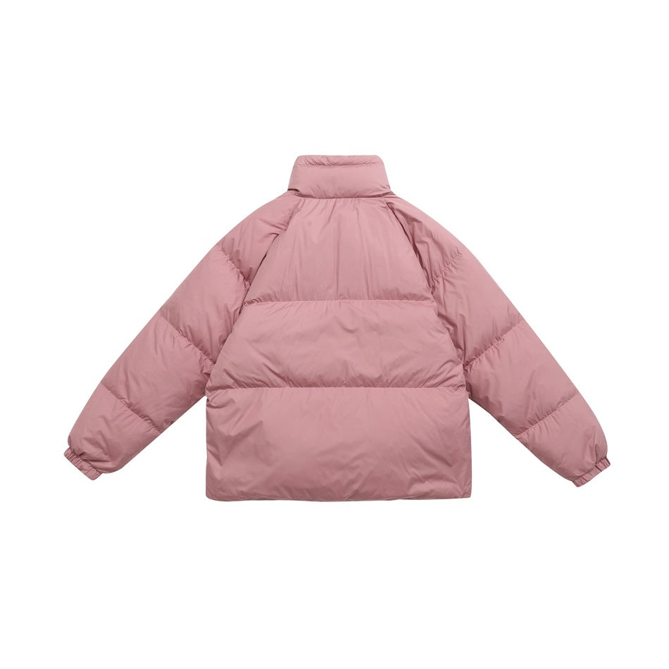 Back view of a dusty pink quilted puffer jacket with a stand collar, horizontal baffles and elastic cuffs.