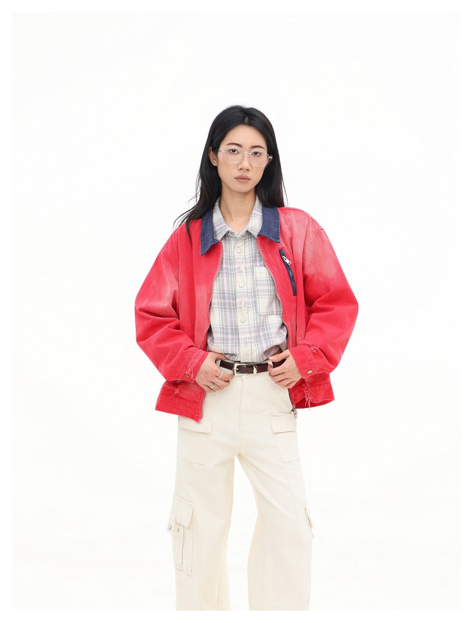 Front view of a model wearing an open faded red jacket with a dark blue collar and vertical chest zip pocket.