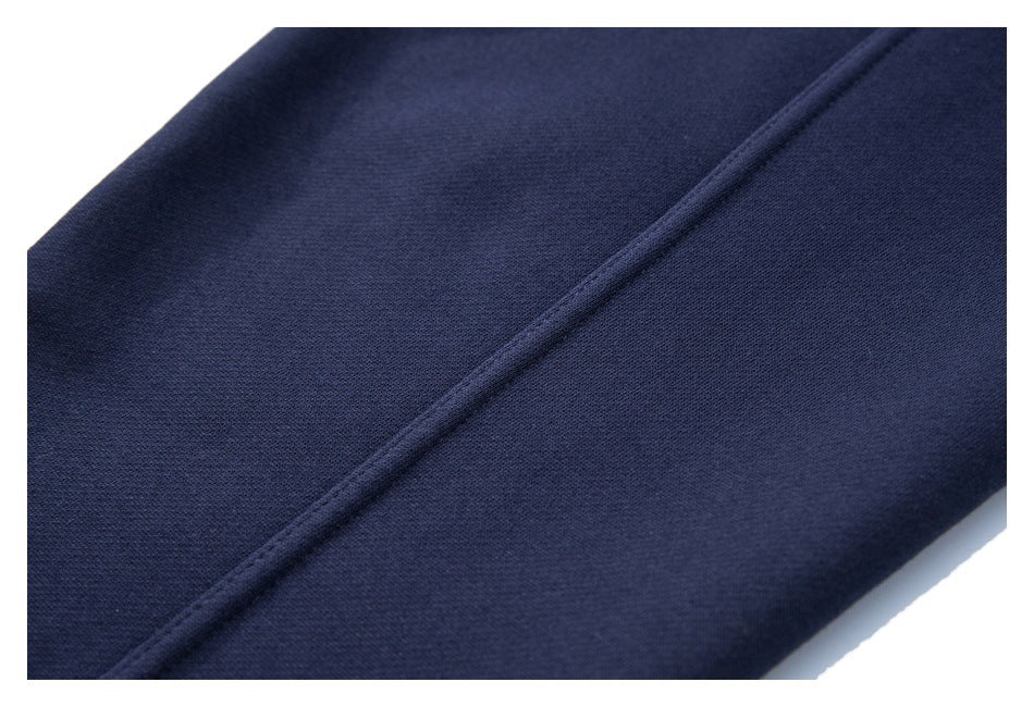 Close-up of a diagonal stitched seam on navy fabric.