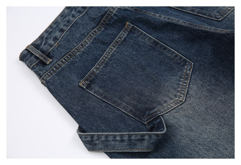 Angled close view of the back of dark blue jeans, showing a plain rear pocket and belt loop.