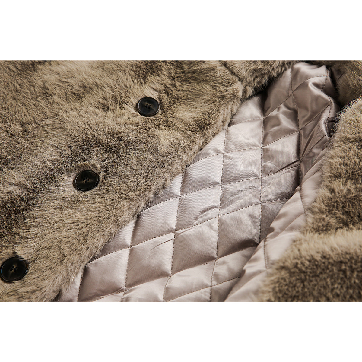 Close-up of the coat's dark front buttons and pale diamond-quilted lining beneath the brown faux fur.
