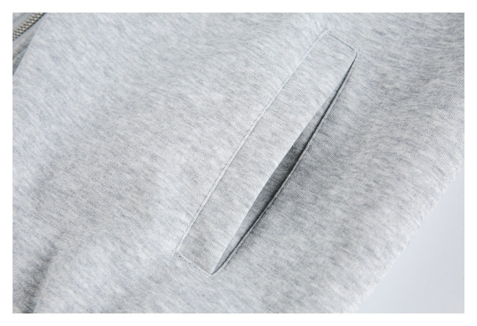 Close-up of a slanted pocket on a light gray hoodie.