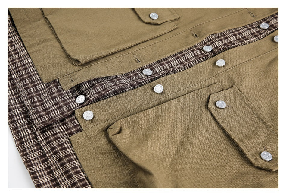 Close-up of khaki overshirts with flap pockets, silver-tone buttons, and brown plaid trim and lining.