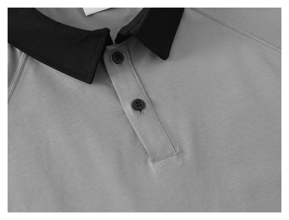 Close-up of a gray polo shirt’s black collar and two-button placket.