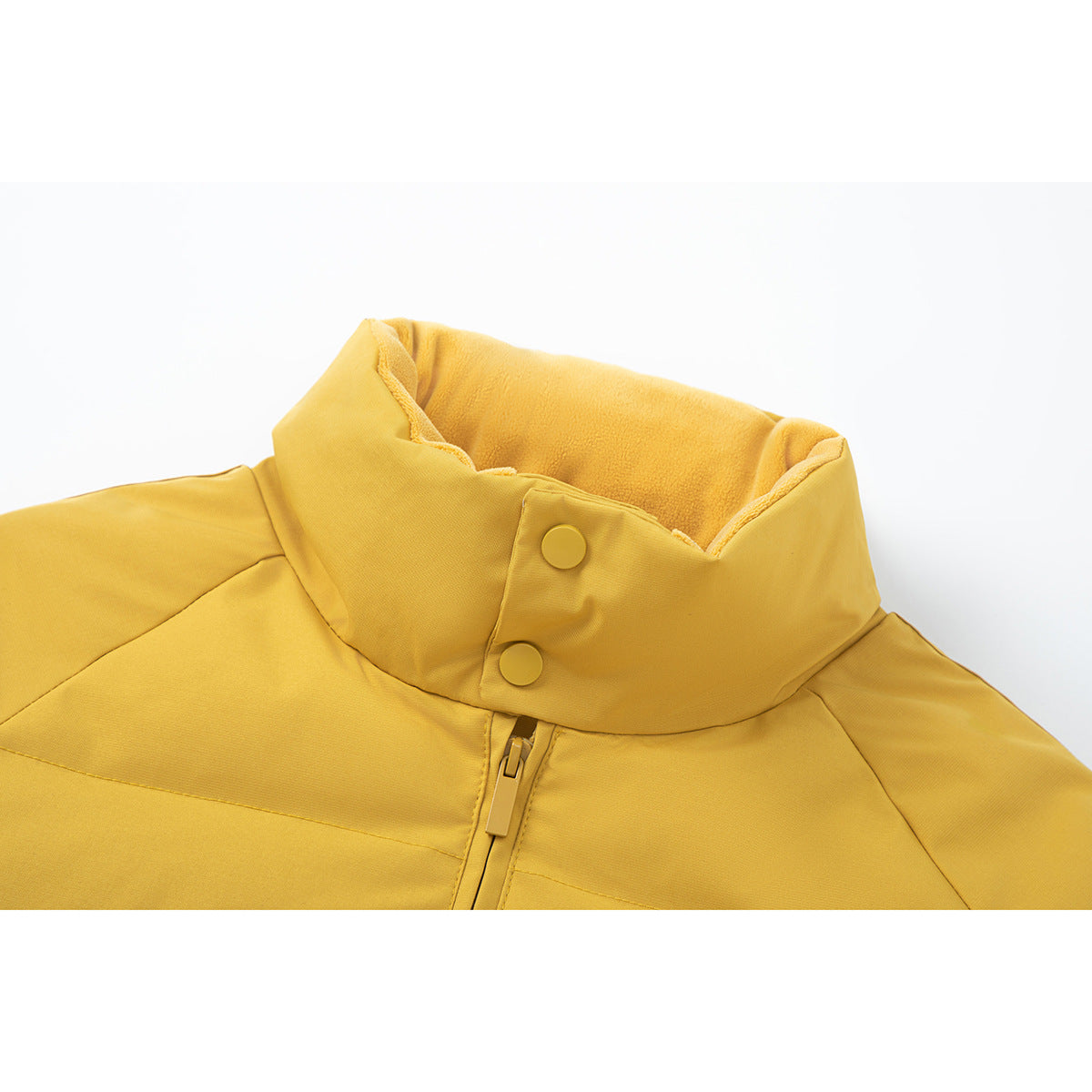 Close-up of a mustard-yellow padded jacket’s tall snap collar and central zipper.