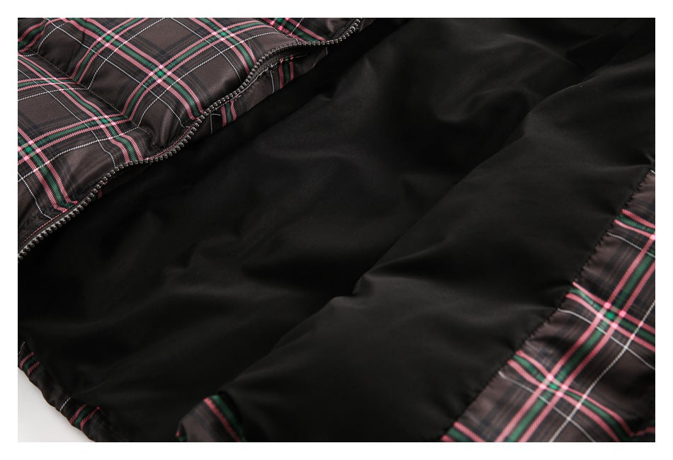 Close-up of black lining inside a dark plaid garment, with a zipper and plaid edging visible.