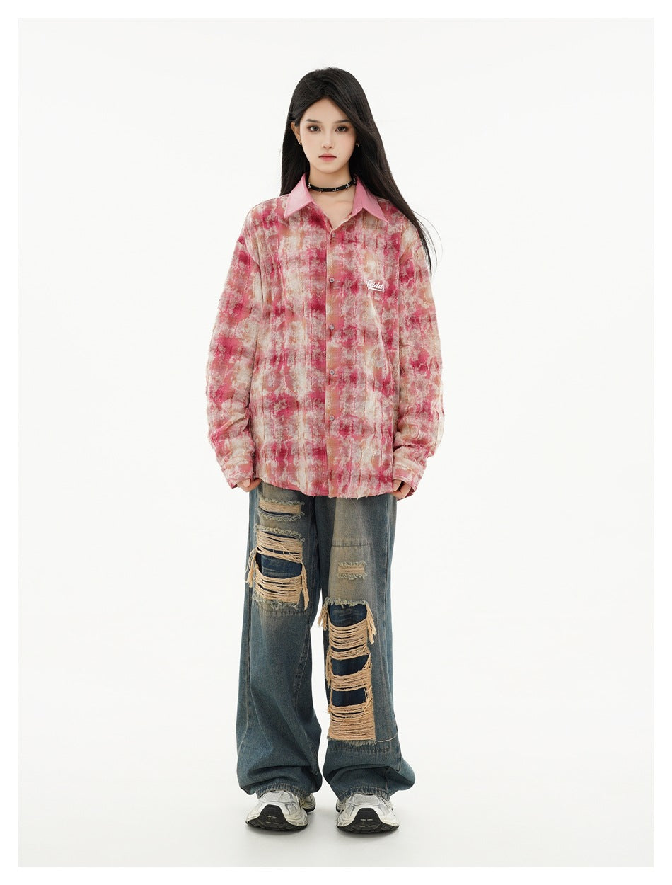 Front view of a model in an oversized pink and beige abstract-print shirt with a pointed pink collar.