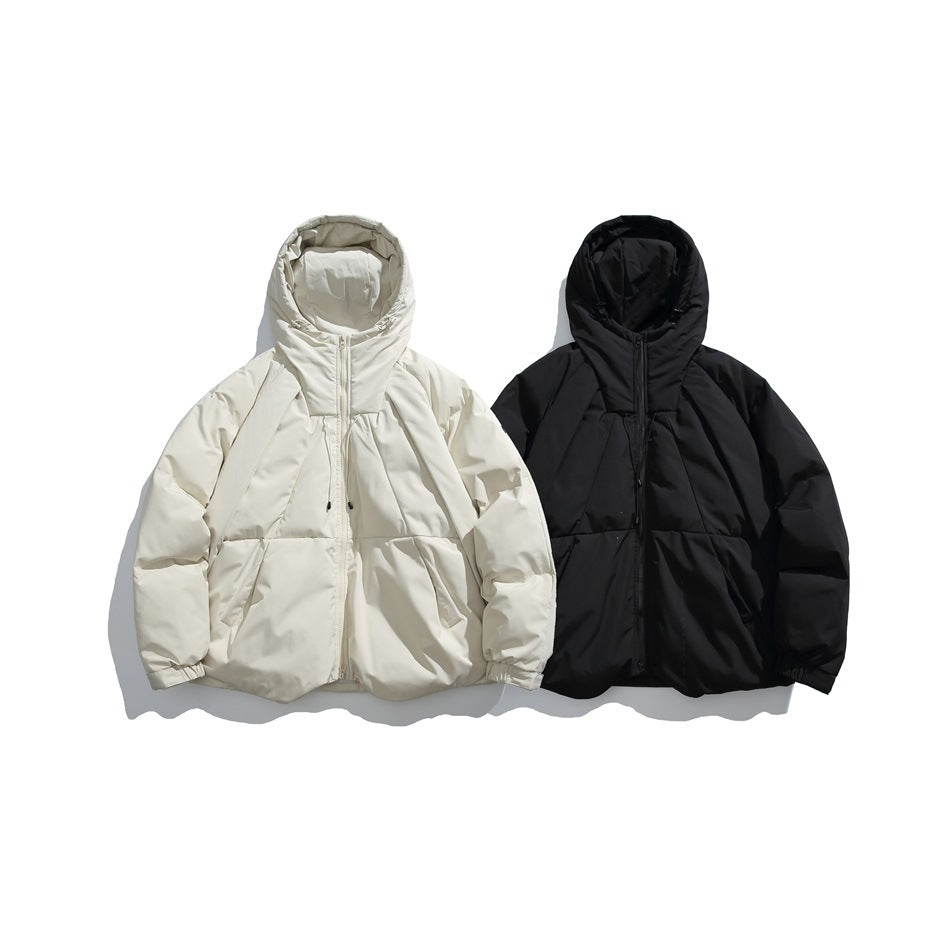 Two hooded zip-up puffer jackets laid flat side by side, one ivory and one black.