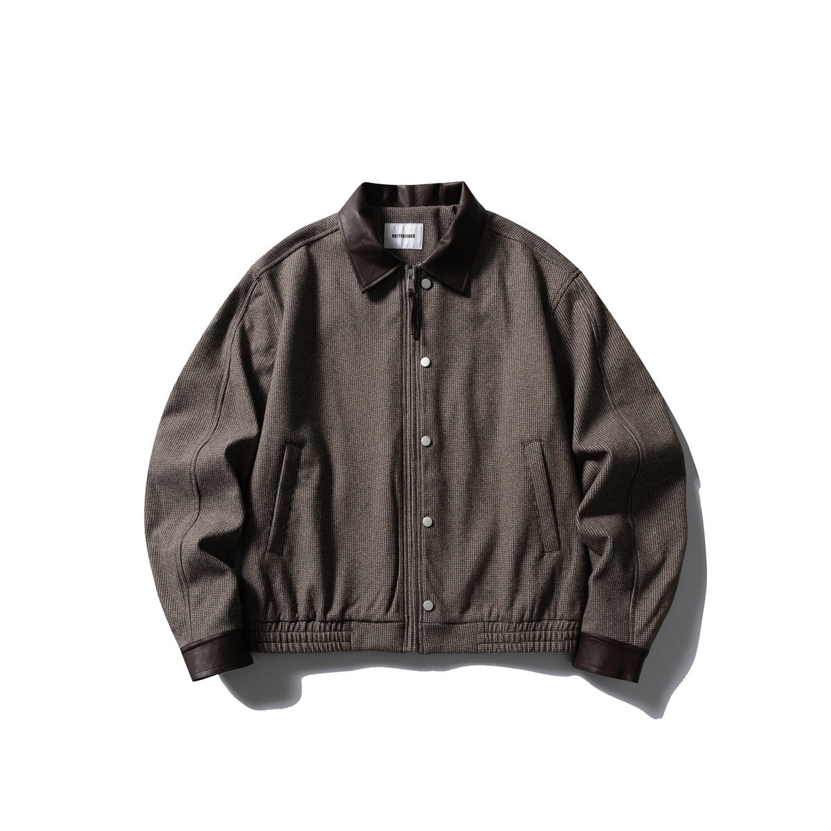 Brown small-check zip jacket with dark brown leather-look collar and cuffs, snap buttons and elastic hem, flat lay