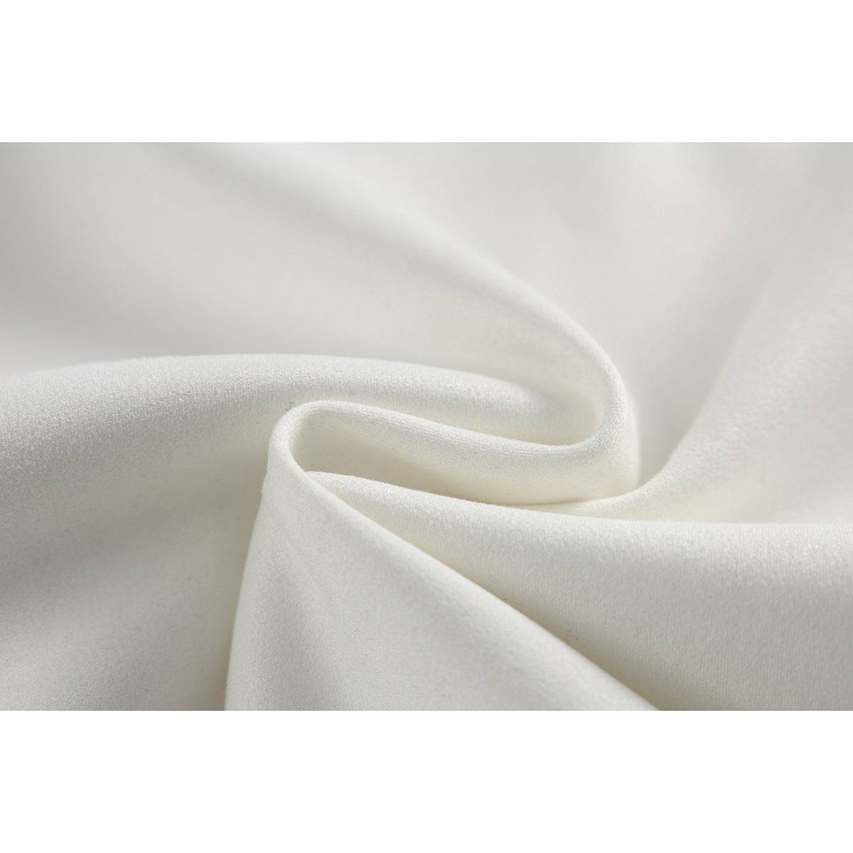Close-up showing the softly folded texture of white jacket fabric.