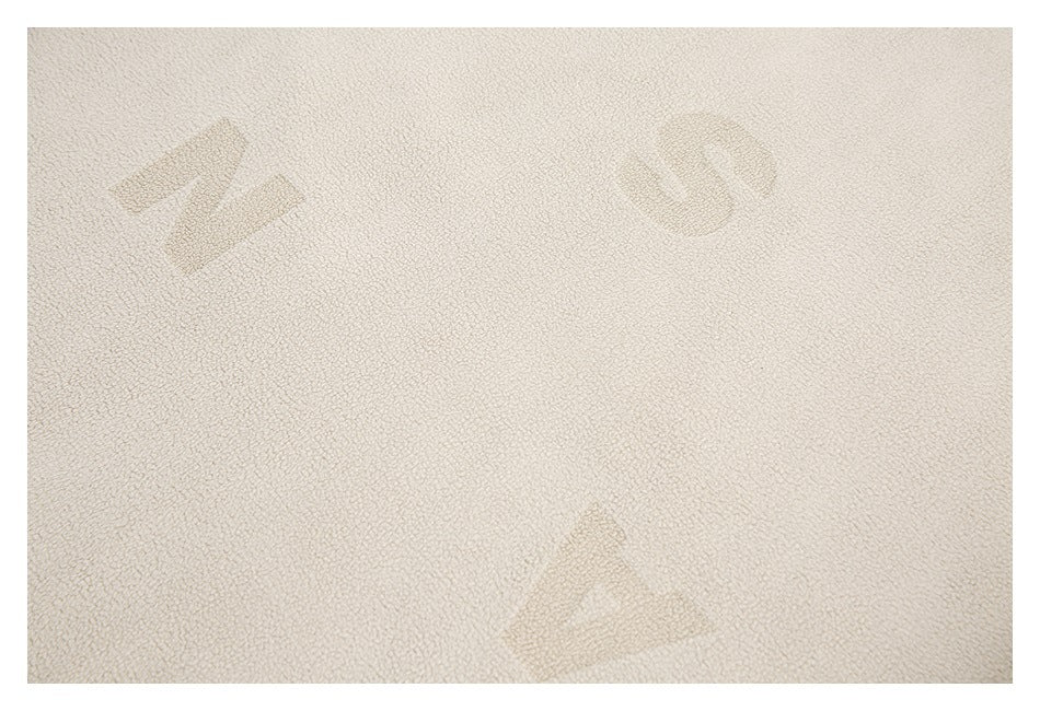 Cream loop-textured fabric with subtle tonal geometric motifs shown close up.