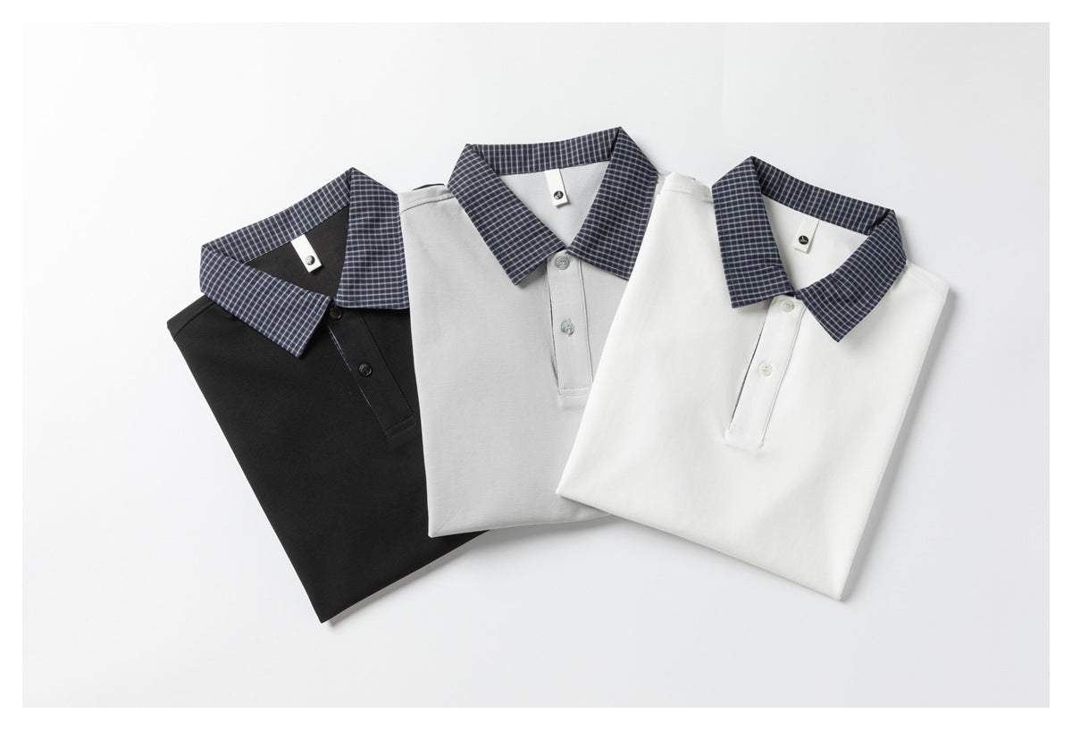 Three folded polo shirts in black, light gray and white, each with a navy checked collar