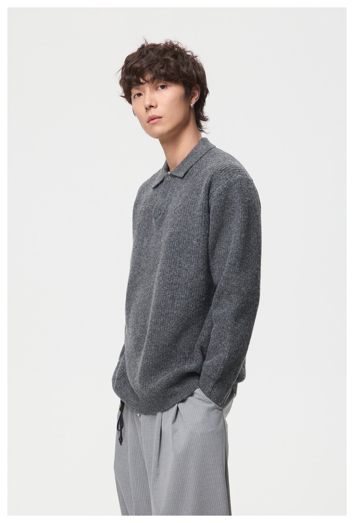 Model in a charcoal gray knit polo, shown from an angled front view with the collar and buttons visible.