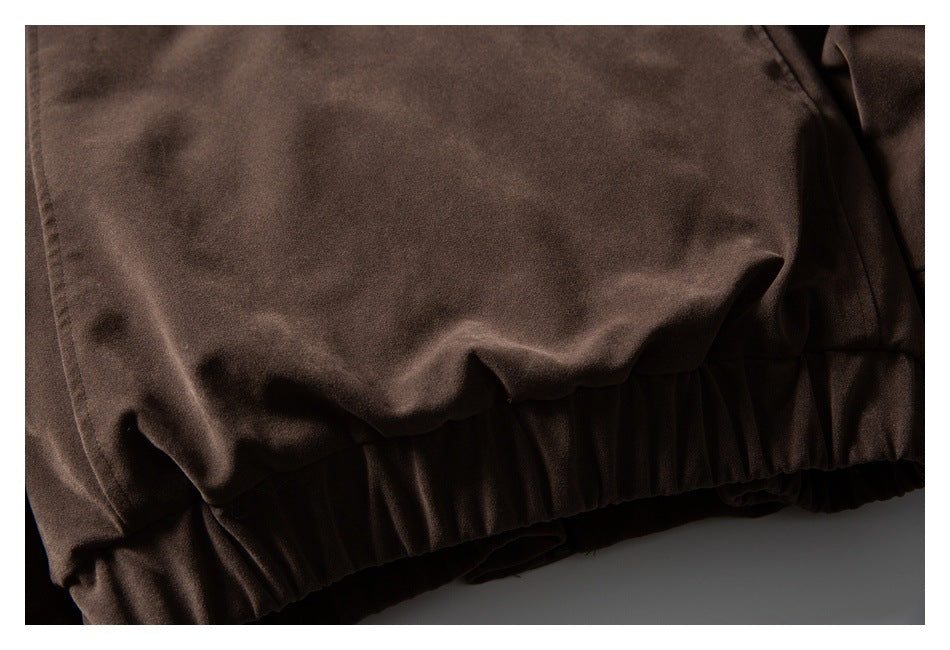 Close-up of a dark brown garment with a gathered elastic hem.
