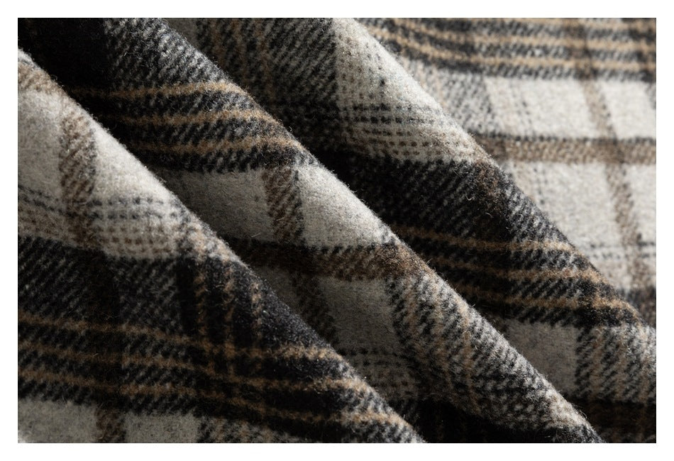 Macro view of the garment’s beige, gray, and brown plaid fabric and fuzzy surface texture.