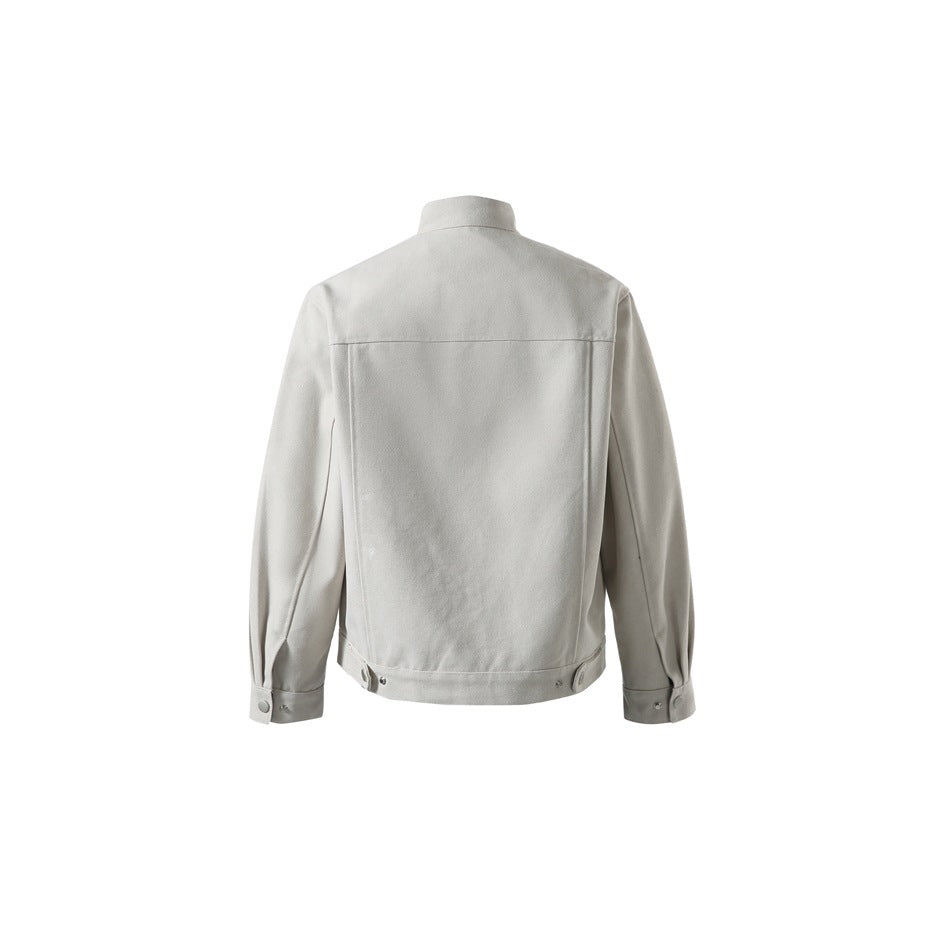 Beige jacket back view with stand collar, back yoke seam, side hem snap tabs and button cuffs