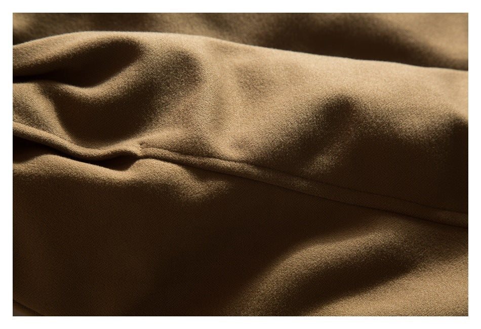 Close-up of brown jacket fabric and a stitched seam.