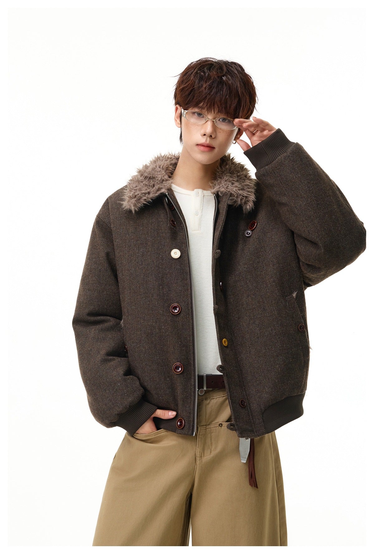 Model wearing a dark brown textured jacket with a faux-fur collar, button details, front zipper and ribbed cuffs.