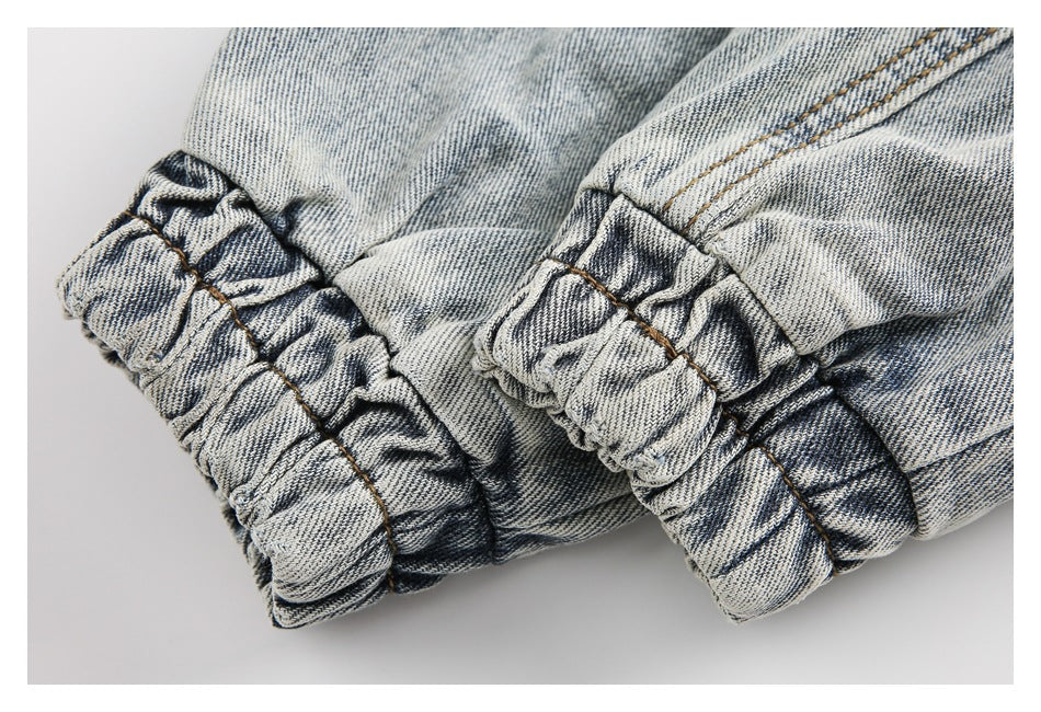 Close-up of a gathered elastic denim edge with visible stitching.